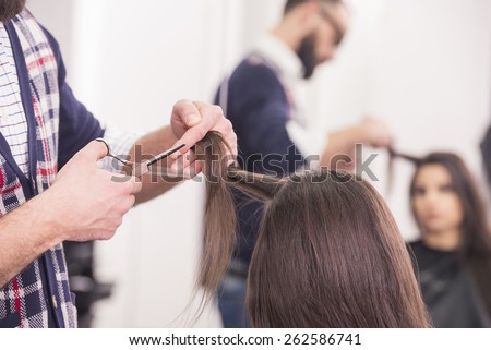 Close-up hairdresser cutting hair a woman in hairdresser salon.