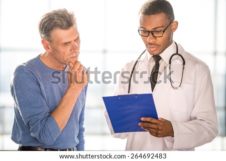 Medical concept. Doctor and patient discussing medical record.