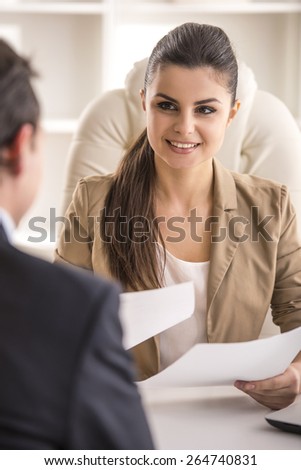 Businesswoman interviewing male candidate for job in office.