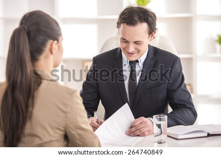 Businessman interviewing female candidate for job in office.