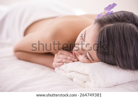 Side view. Beautiful asian woman having massage in beauty salon.