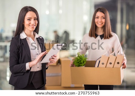 Two female businesswomen moving into a new office