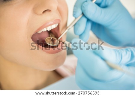 Dentist examining a patient\'s teeth in the dentist.