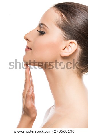 Side view of beautiful face of young woman with clean fresh skin isolated on white background.