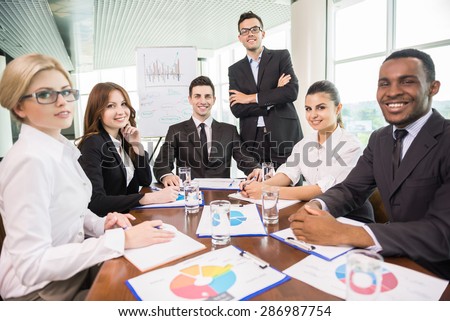 Business people sitting in conference room and working.
