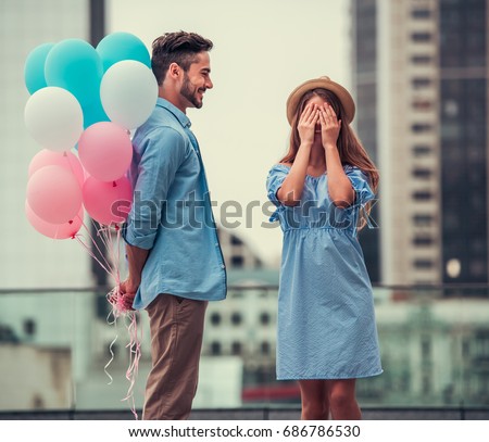 Similar – Image, Stock Photo Romantic couple walking on foamy sea waves