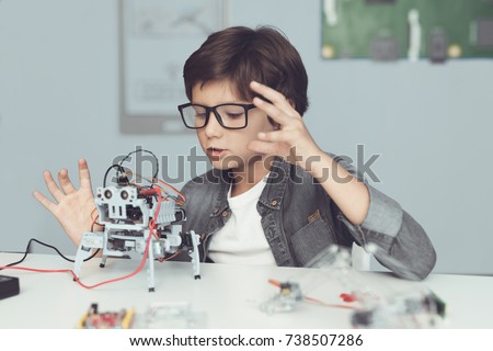 Similar – Image, Stock Photo Cute boy holds on to the horizontal bar and looks at the camera