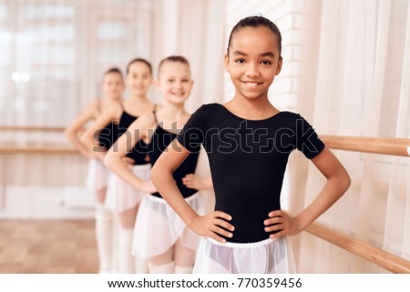 Image, Stock Photo Young smiling ballerina in black dress sitting on a park bench.