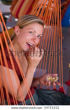 Girl eating peanuts in hammock chair