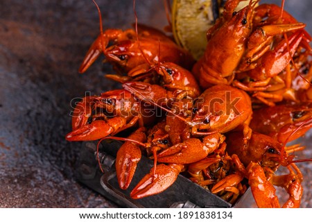 A pile of tasty boiled crawfish. Boiled red crayfish or crawfish with  herbs on a table. Crayfish party, restaurant, cafe, pub menu. ストックフォト © 