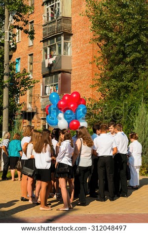 Rostov - on - Don, Russia - September 1, 2015: School line is in schoolyard with first-grade pupils and teacher. Children go back to school. The Knowledge Day in Russia, first day of school.