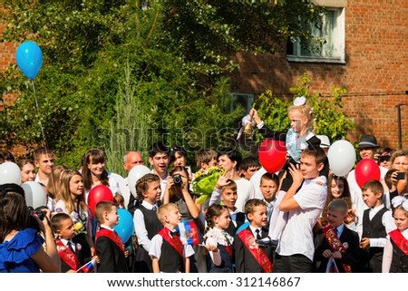 Rostov - on - Don, Russia - September 1, 2015: School line is in schoolyard with first-grade pupils and teacher. Children go back to school. The Knowledge Day in Russia, first day of school.