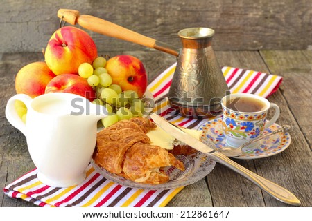 summer breakfast with croissants, coffee and fruit