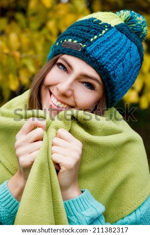 Beautiful young woman covering herself with a blanket