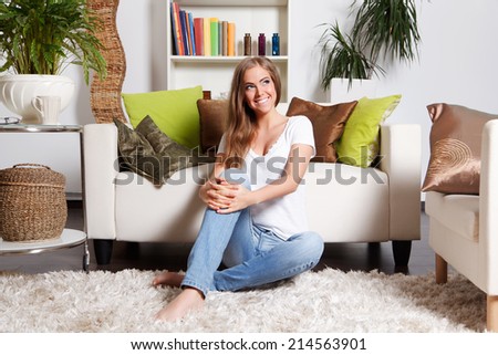 Beautiful young woman relaxing in the living room