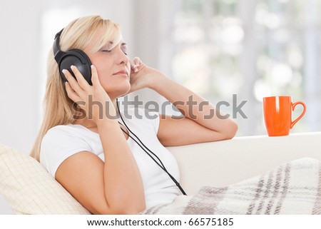 Beauty, blondie woman listening music with earphones
