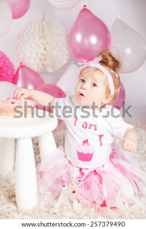Cute baby eating the birthday cake
