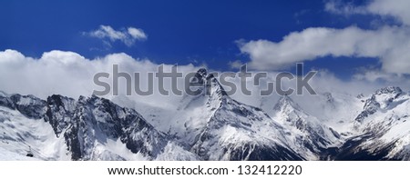 Panorama of snowy mountains. Caucasus Mountains. Ski resort Dombay.