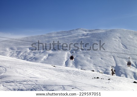 Gondola lifts and ski slope at nice sun day. Caucasus Mountains, Georgia. Ski resort Gudauri.