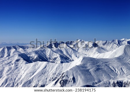 Winter snowy mountains at nice sun day. Caucasus Mountains, Georgia. Ski resort Gudauri.