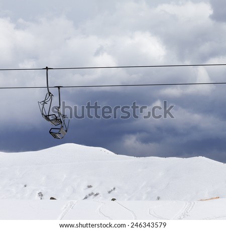 Chair lifts and off-piste slope at windy gray day. Caucasus Mountains, Georgia. Ski resort Gudauri.