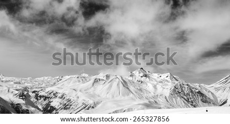 Black and white snowy mountains at wind day. Panorama Caucasus Mountains, Georgia. Ski resort, Gudauri.