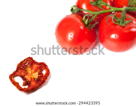 Bunch of raw tomatoes with water drops and dried slice. Isolated on white background