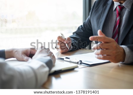 Employer or recruiter holding reading a resume during about colloquy his profile of candidate, employer in suit is conducting a job interview, manager resource employment and recruitment concept. Stock foto © 