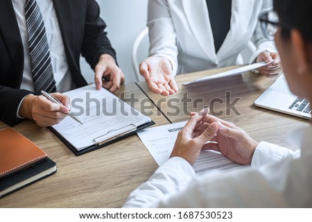 Employer or committee holding reading a resume with talking during about his profile of candidate, employer in suit is conducting a job interview, manager resource employment and recruitment concept. Stock foto © 