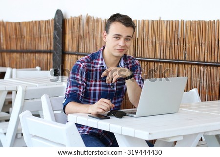 Successful freelancer work on laptop computer in tropic cafe, stylish hipster use modern device