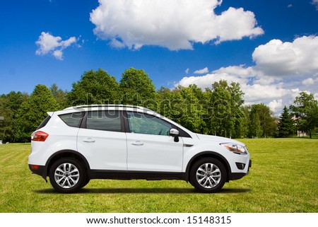 A white SUV in the green field