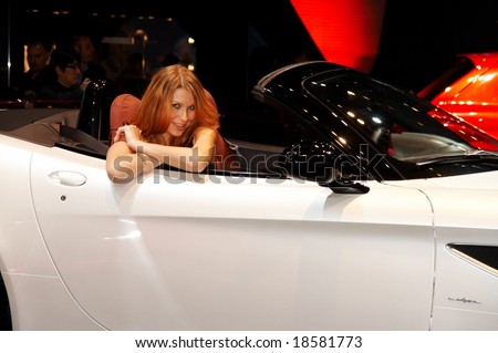 PARIS, FRANCE - OCTOBER 02:  female model posing near car at Paris Motor Show 2008 on October 02, 2008