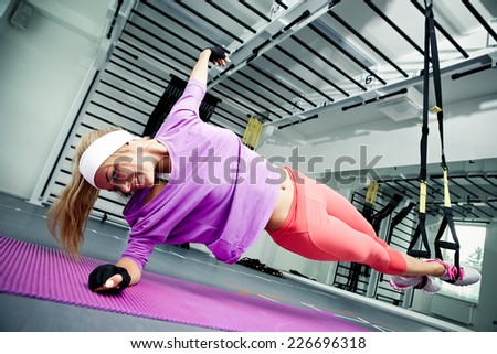 Young woman streching muscles making functional training