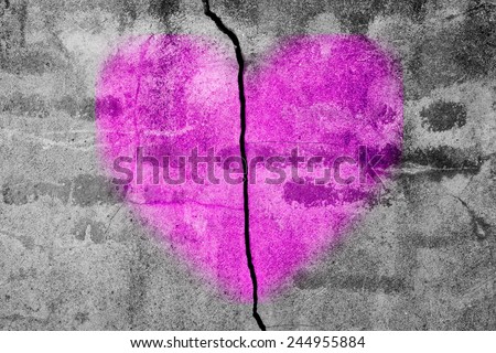 Purple heart sprayed on a broken brick and mortar wall