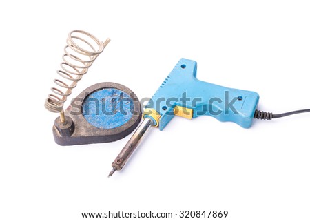 Old rusty blue soldering iron standing on the holder with soft shadow, isolated on white background