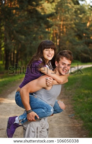 Young man giving piggyback ride to woman
