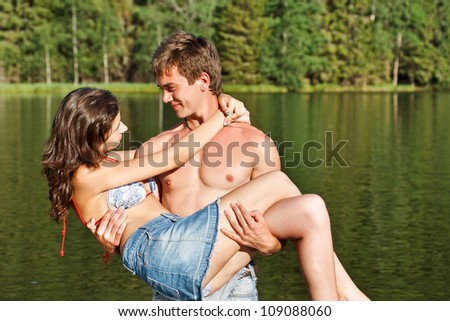 Young couple in lake water lost in love