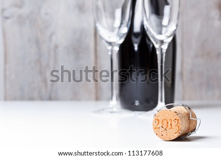 Champagne cork with background glass and bottle