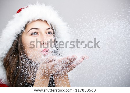 Santa Claus woman blowing snow from her palm