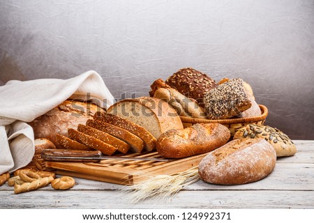 Collection of baked bread on wooden background