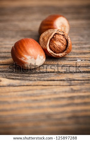 Dried hazelnuts on old wooden background