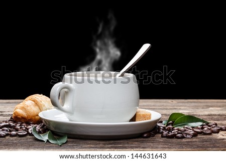 White cup of hot coffee with steam