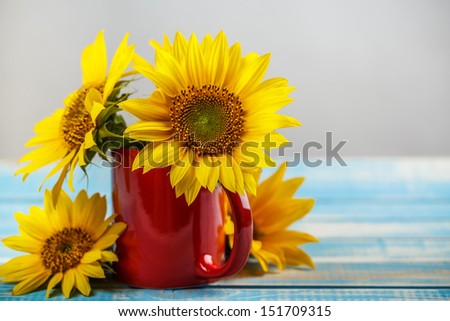 Bouquet of sunflowers in red cup