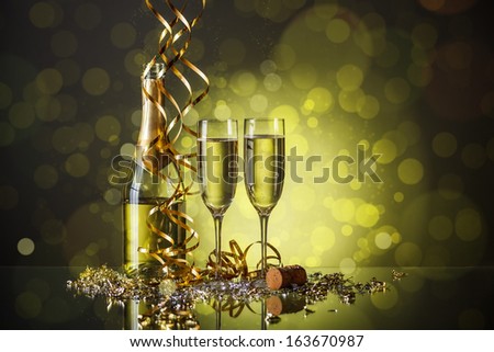 Two champagne glasses with bottle ready to bring in the New Year