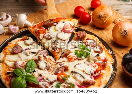 Slices of sausage pizza on a metal pizza pan