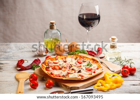 Fresh homemade pizza served with red wine