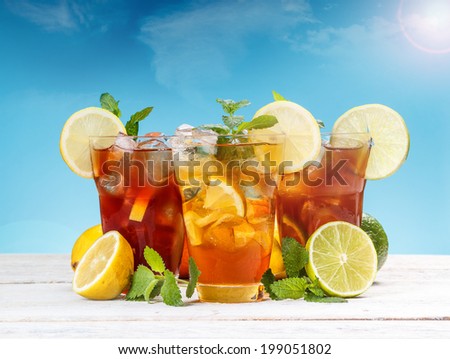 Fresh and cold ice tea with sliced lemon and mint