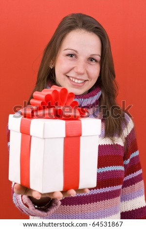 Girl holding a gift , on red background