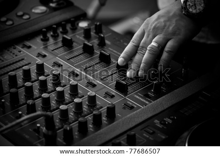 DJ playing music on professional mixing controller