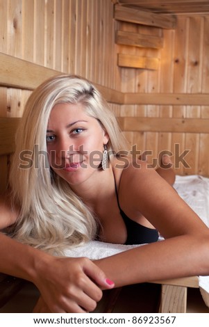 Beautiful young woman relaxing in the sauna